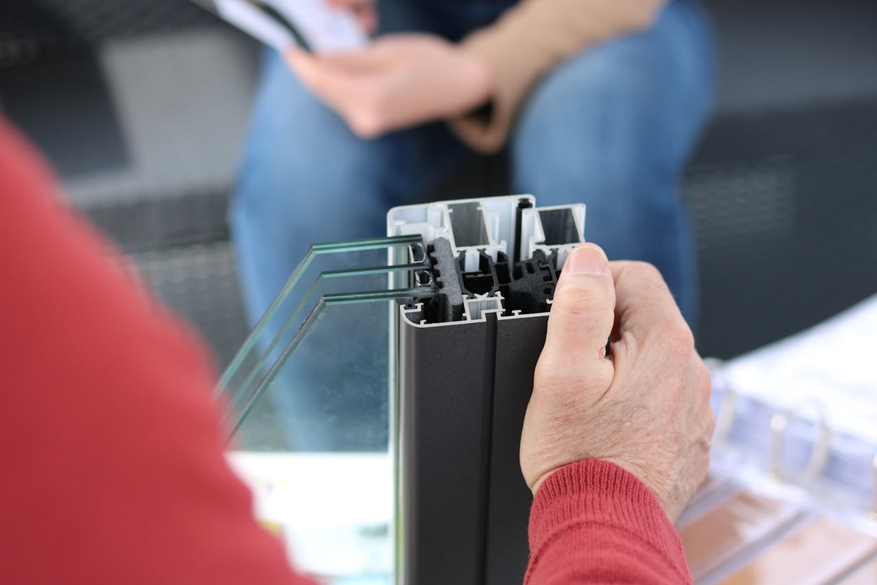 Person Holding Black Aluminum Frame